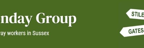 Green banner with white text: "The Monday Group," "Voluntary rights of way workers in Sussex," and a direction sign pointing to "Stiles," "Gates," "Steps," and "Clearance.