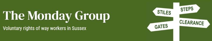 Green banner with white text: "The Monday Group," "Voluntary rights of way workers in Sussex," and a direction sign pointing to "Stiles," "Gates," "Steps," and "Clearance.